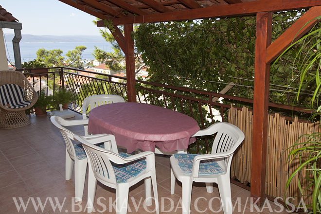 large terrace in pine tree shadow with sea view and panorama of Baska Voda