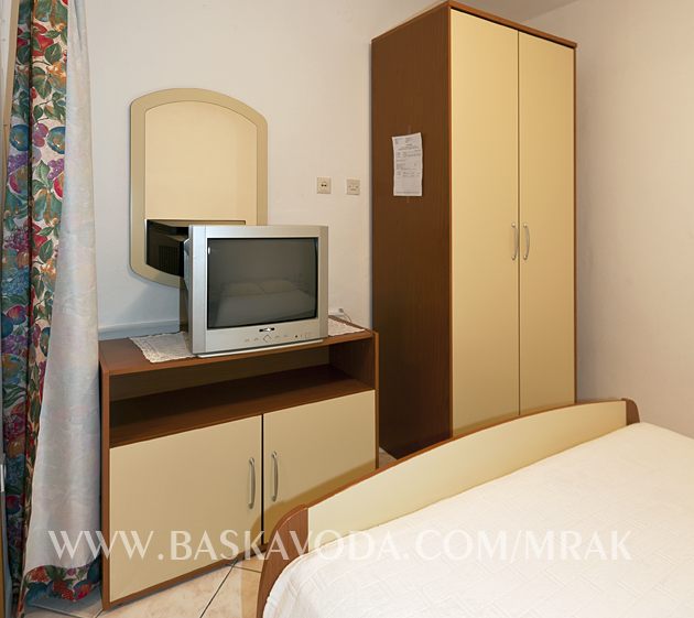 TV set and dressing mirror in bedroom