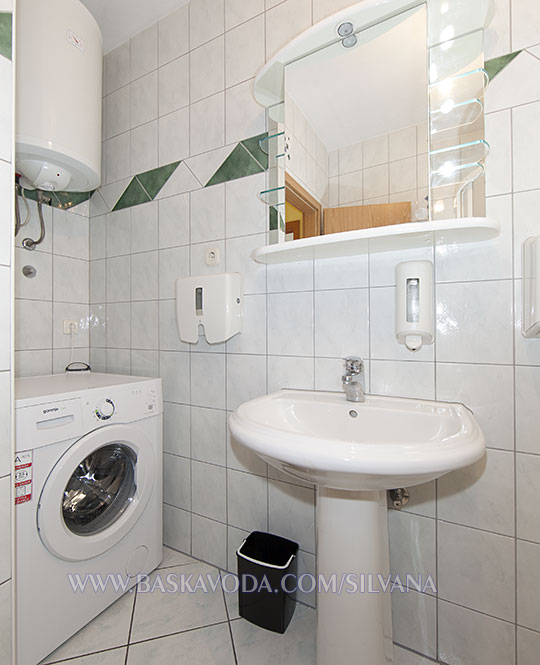 bathroom with laundry washer