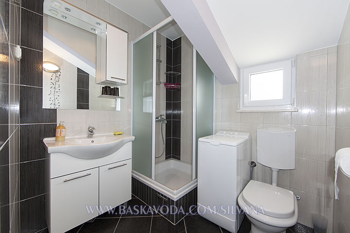 bathroom with laundry washer